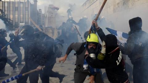 Protesters clash with police officers during a demonstration against the agreement reached by Greece and Macedonia to resolve a name dispute