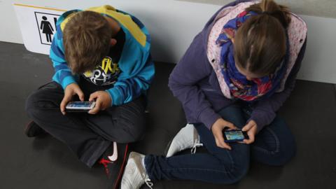 Children using smartphones