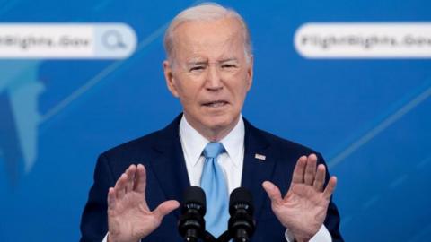 US President Joe Biden delivers remarks at an event on holding airlines accountable by protecting consumers when there are flight delays or cancellations, in the Eisenhower Executive Office Building on the White House complex in Washington, DC, US