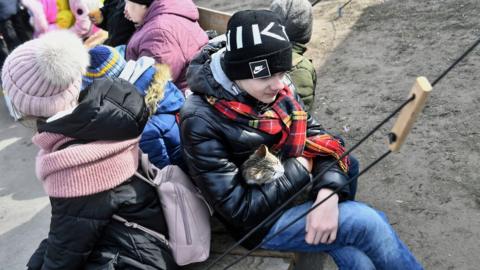 Ukrainian refugees wait for a train at the railway station in Lviv, western Ukraine