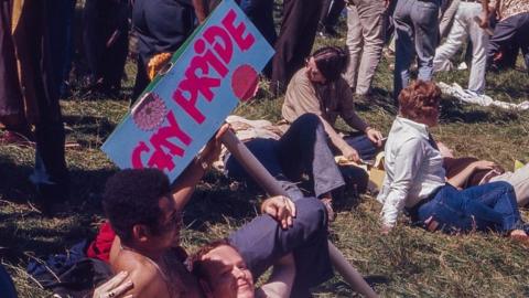 Two men lying down in grass