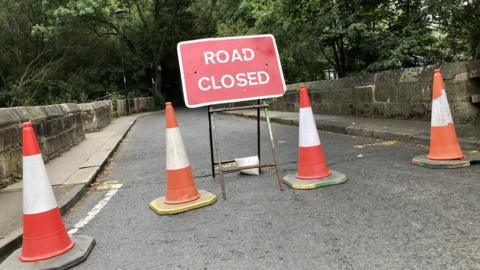 Traffic cones and a "Road closed" sign on Salters Bridge