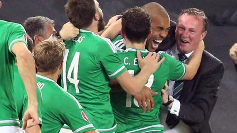 Josh Magennis runs over to Michael O'Neill