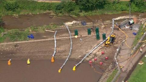 The fire service is continuing to pump water from the reservoir, and sandbags are still being dropped by RAF helicopters.