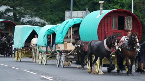 A convoy of horse drawn wagons arrive in Appleby, Cumbria, ahead of the annual Horse Fair