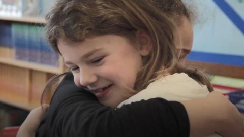 Two girls hugging