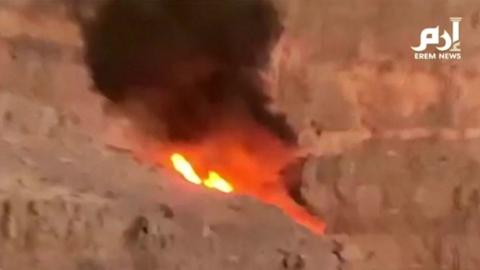 A still image taken from video footage shows a ball of flame where the helicopter crashed