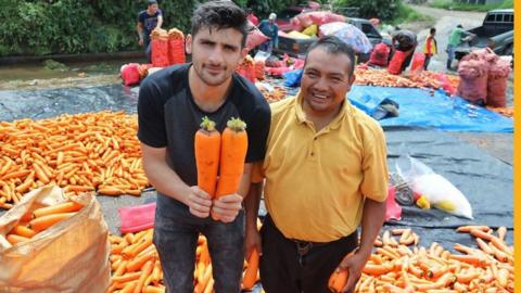 Ben Zand and two giant carrots