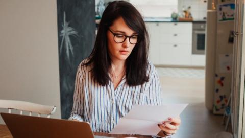 Stock photo of woman looking at financial statement