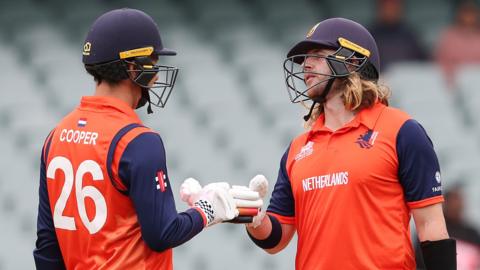 Netherlands batters Tom Cooper (left) and Max O'Dowd (right) touch gloves