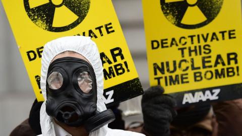 An anti-nuclear activist wearing gas mask is pictured during a protest against the lack of safety of Belgian nuclear power plants in 2016