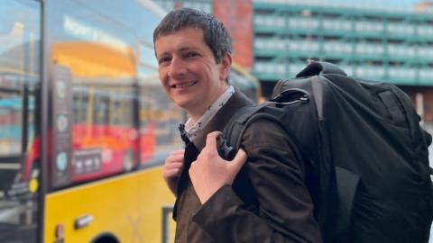 Andrew Cowell boarding a bus in Derby