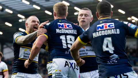 Leeds' James McDonnell is congratulated by Blake Austin after his try against Huddersfield.