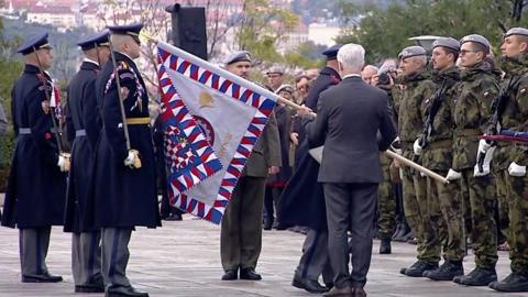 Czech president in a suit hits soldier with a flagpole