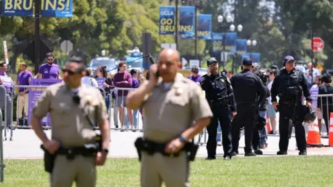California Highway Patrol officers and UCLA police members stand guard near an encampment in support of Palestinians at the University of California Los Angeles