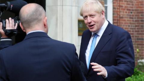 Britain"s Prime Minister Boris Johnson gives an interview on arrival at Stormont House