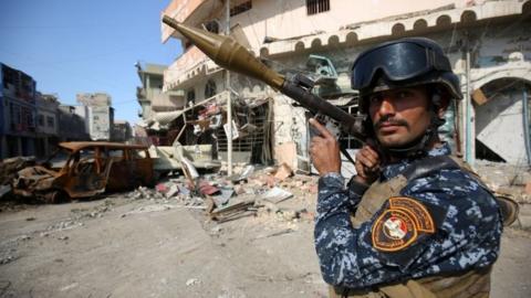 A member of the Iraqi security forces stands guard on the front line at the Old City of Mosul during fighting to oust so-called Islamic State, 26 March 2017