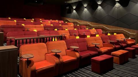 Red seats inside the Avenue cinema at CastleCourt