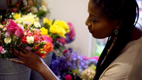 Kamilah holding a bunch of flowers