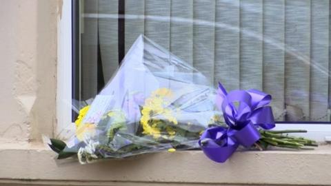 Floral tribute on the window ledge of the property