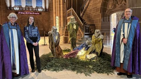 Paulina Kurzydlowska and the Dean of Liverpool next to the nativity scene