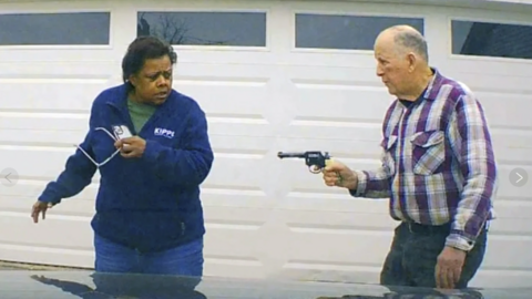 Police image shows the suspect pointing a gun at the alleged victim
