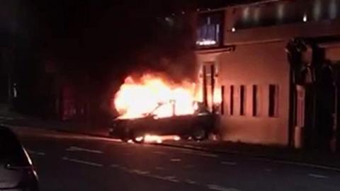 Car on fire outside nightclub