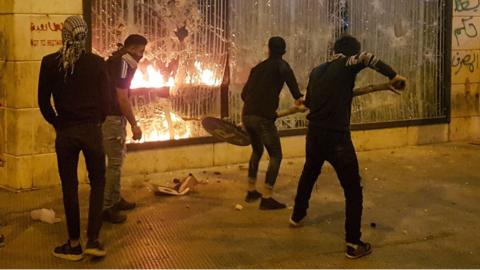 Protesters attack a building in the Lebanese city of Tripoli on 27 April 2020