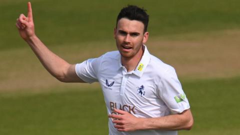 Nathan Gilchrist celebrates taking a wicket for Kent