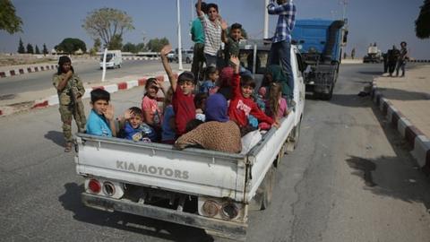 Civilians are seen on their way to Tal Abyad, part of the "safe zone" on the Syria-Turkey border