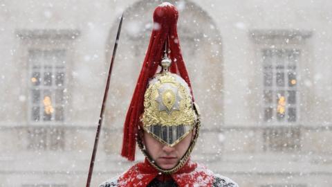 A Household Cavalry Guard stands in the blizzard as heavy snow hits Westminster