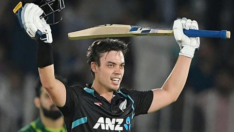 New Zealand batter Mark Chapman raises his helmet and bat after hitting a century against Pakistan