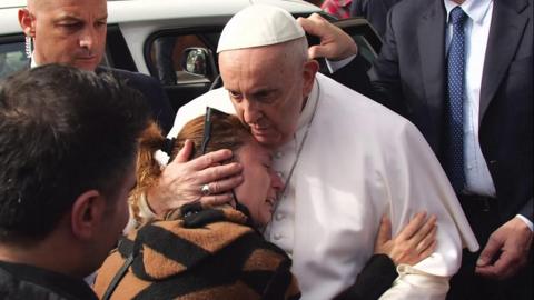 The Pope comforts an emotional well wisher outside the hospital