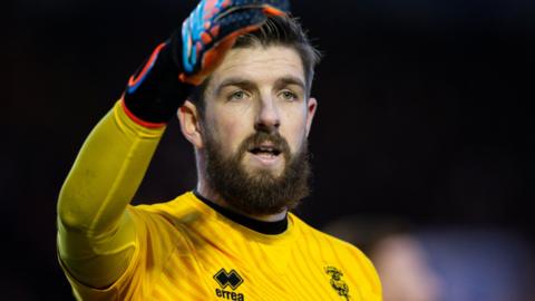 Josh Vickers in action for Lincoln City