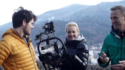 Daniel Roher, Yulia Navalnaya and Alexei Navalny on film set