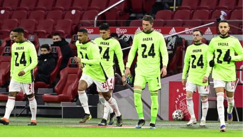 Ajax players wearing shirts in support of Cameroon goalkeeper Andre Onana