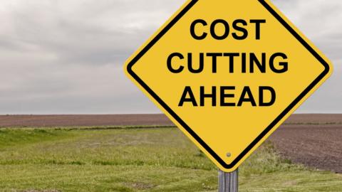 Sign warning of cost cutting