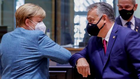 German Chancellor Angela Merkel bumps elbows with Hungary"s Prime Minister Viktor Orban at the start of the second face-to-face European Union summit since the coronavirus disease (COVID-19) outbreak, in Brussels, Belgium October 1, 2020