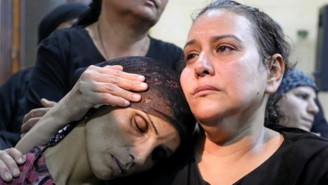 A mother of one of the victims of an attack on a group of Coptic Christians attends a funeral at the Sacred Family Church in Minya