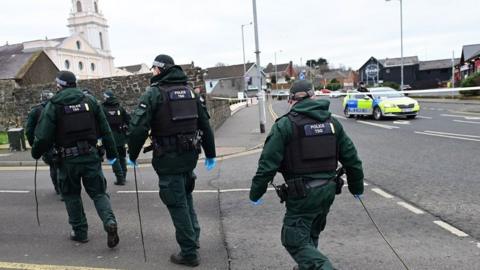 Police searching Whiteabbey assault scene