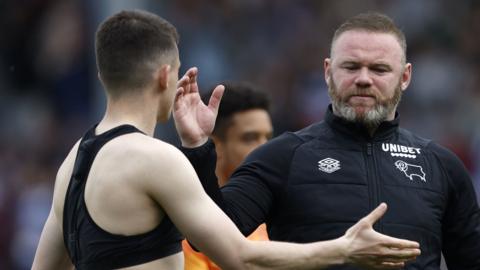 Wayne Rooney goes to give one his players a high five