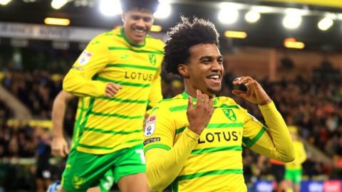 Sam McCallum of Norwich City celebrates scoring the opening goal against Huddersfield Town