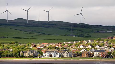 A wind farm with a small town of Ardrossan in the foregound