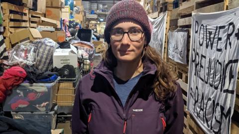 Marguerite Combes in a warehouse in Calais