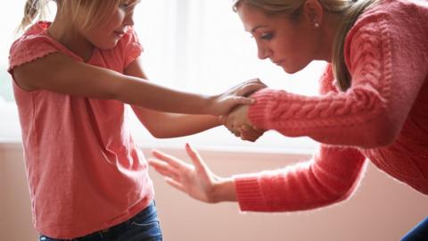 Woman smacking child