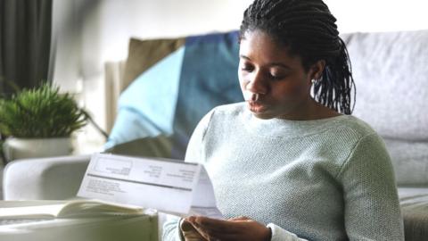 Woman looking at an energy bill.