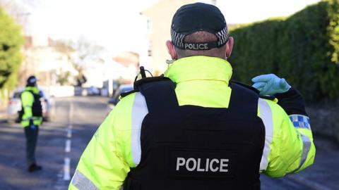 A police officer directs traffic