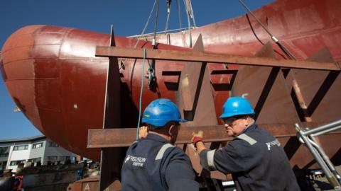 selection of images showing the engineering operation at Ferguson Marine (Port Glasgow) shipyard to lift the bulbous bow into place on the bow section of Hull 802.