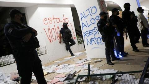 Riot police officers keep watch at the Municipal Palace after a protest to demand justice for the murder of Blanca Alejandrina, known as Alexis, which was disbanded by the police with shots into the air to disperse demonstrators who were vandalizing the government premises, in Cancun, Mexico November 9, 2020