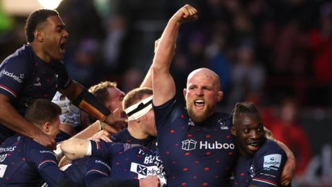 Bristol players joyfully celebrate Rich Lane's try